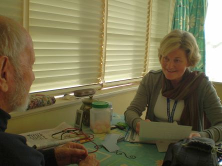 Hospice Palliative care nurse Joan Doyle dicussing symptoms with a patient July