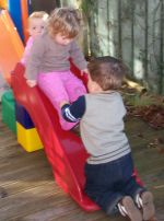 A group of young children playing on the slide at All About Kidz in Feilding