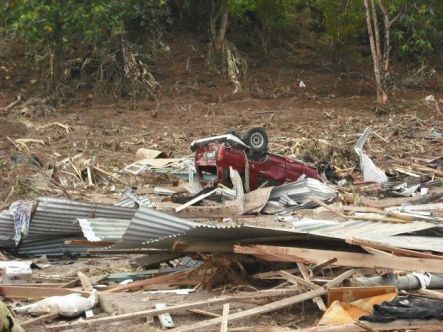 A red van up-ended on one of the washed-out Samoan beach hit by the tsunami