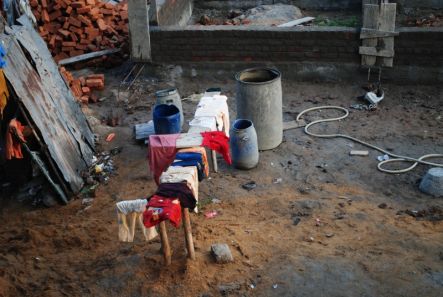 Barrels and loose bricks dominate a construction site in India