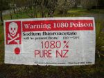 A protest message painted on a 1080 warning sign