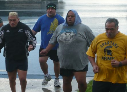 A group of overweight men work out at