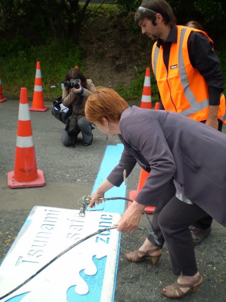 Blue Line Tsunami Feb Mayor Celia Wade Brown with spray gun and stencil small