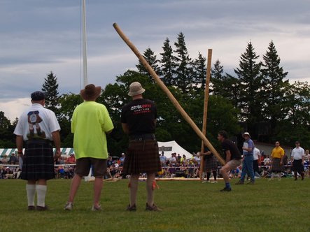 Cosmo Competing Tossing the Caber