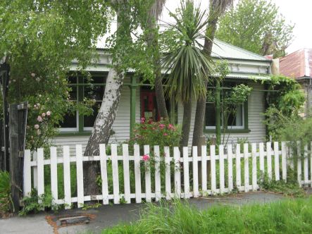 Loop Deserted yellow stickered cottage Ground movement since earthquakes highlighted by picket fence small